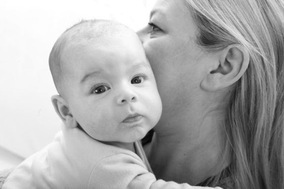 Black and white baby portrait with mum.